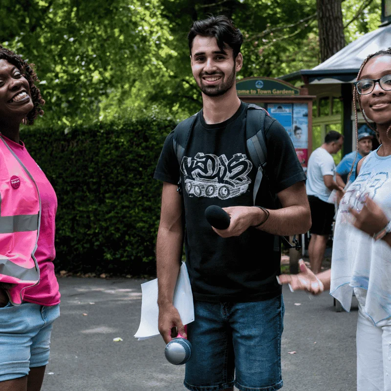 group of people, sat on different coloured couches, writing