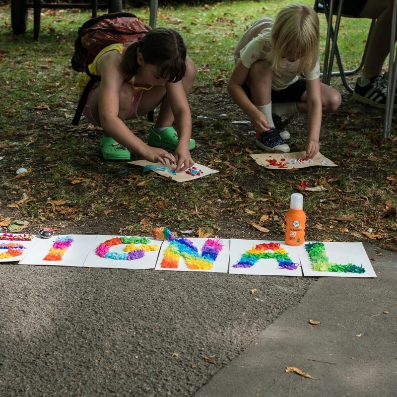 child making chalk drawing on ground